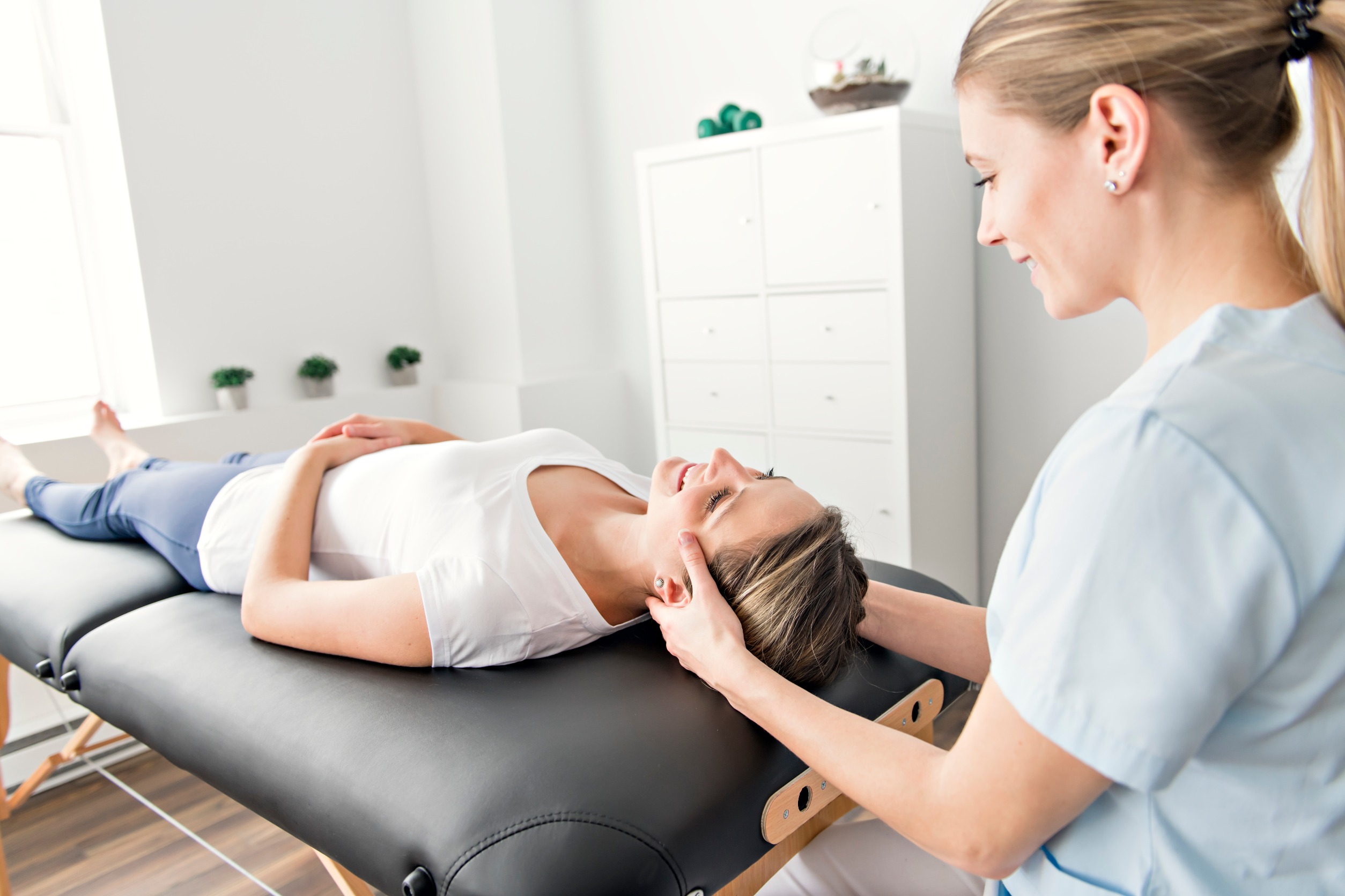 female chiropractor working on patient