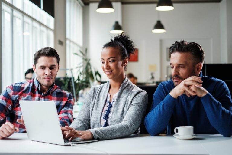 group of start up professionals working on a laptop